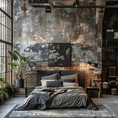 an industrial style bedroom with brick walls and exposed ceilings, large windows, black bedding