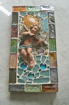 a small tile with an angel on it