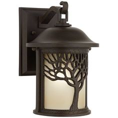 an outdoor wall light with a tree design on the front and side panels, one light is