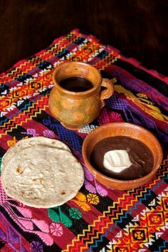 there are two plates with food on the table next to each other and a cup of coffee