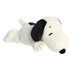 a white stuffed dog laying on its side