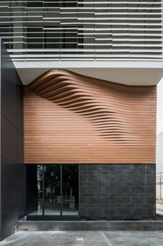 a building with wooden slats on the front and side of it's facade