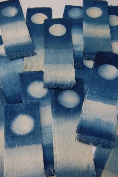 several pieces of blue and white cloth with circles on them