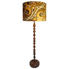 a lamp that is sitting on top of a table with a brown and gold shade