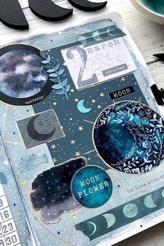 a scrapbook with space and moon images on it