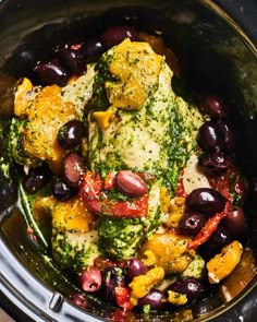 a slow cooker filled with chicken, olives and broccoli