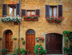 an old building with flower boxes on the windows