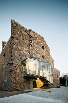 an old brick building with stairs leading up to it