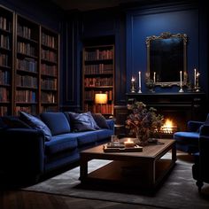 a living room filled with blue couches and bookshelves next to a fireplace