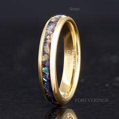 a gold ring with blue and yellow marble inlays