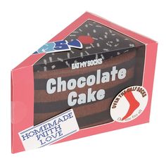 an open box with chocolate cake inside on a white background and stickers attached to it