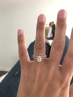 a woman's hand with a wedding ring on it