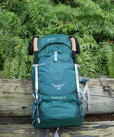 a backpack sitting on top of a wooden bench