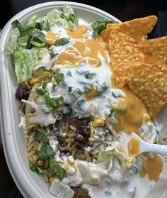 a white plate topped with salad and tortilla chips