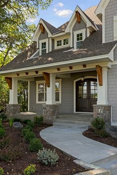 a gray house with white trim and windows