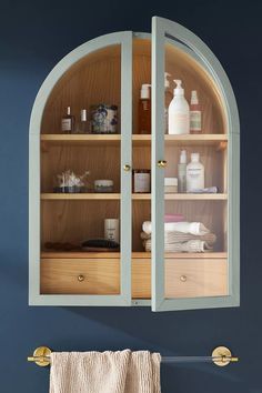 a bathroom with blue walls and white trim on the cabinet doors is shown in this image