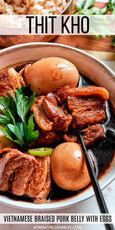 a bowl filled with meat and vegetables next to rice