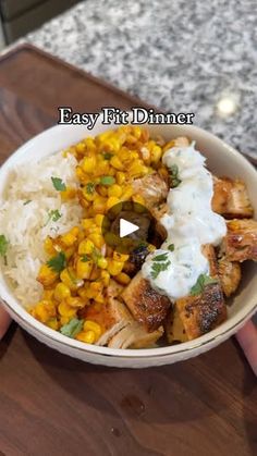 someone holding a bowl of food with rice and chicken