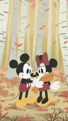 two mickey and minnie mouses in the woods with leaves on them, one is touching the other's face