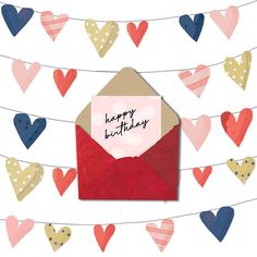 a red envelope with a happy birthday card in front of some hearts on a string