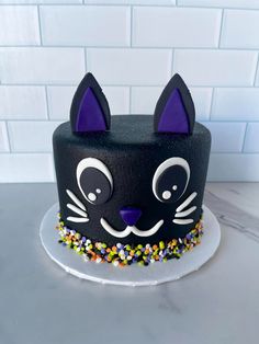 a black cat cake with sprinkles on top