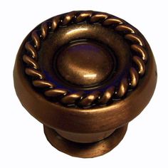 an antique brass cabinet knob with braided design