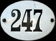 a black and white sign with the number twenty seven on it's front side