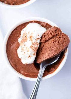 two bowls filled with chocolate pudding and whipped cream