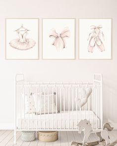 a baby's room with two pictures on the wall