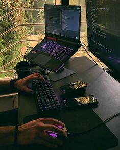 a person sitting at a desk with a laptop and mouse in front of them on their lap top