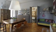 a living room filled with furniture and a wooden table