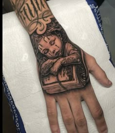 a person's hand with a tattoo on it