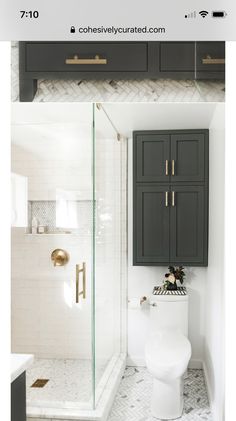 a white toilet sitting in a bathroom next to a walk in shower and wooden cabinets