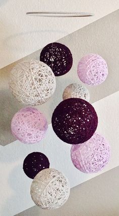 several balls of yarn hanging from the ceiling