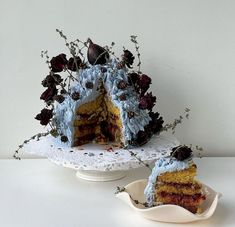 a piece of cake with blue frosting and flowers