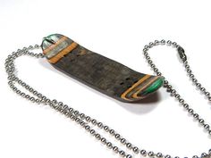 a necklace with a wooden object attached to it