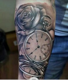 a man with a clock and roses tattoo on his arm