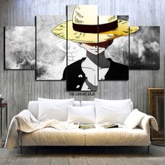 a living room with a couch and three paintings on the wall, one is wearing a hat