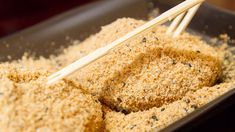 two sticks sticking out of some food in a bowl