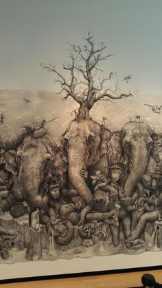 an elephant is standing in front of a painting with many elephants on it's back