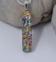 "I have fused 2 layers of dichroic glass with clear on top of the layers to achieve the effect in this pendant. The bottom layer of the dichroic is backed with black glass. The size of the pendant is 1 3/4 inch by 7/16 inch. I do not include the bail in this measurement, just the glass. The pendant is set with a sterling silver plated jewelry finding. The pendant will come with a 18\" sterling silver plated snake chain with a lobster claw clasp. It will also be in a cotton lined gift box. The co Fancy Garden Party, Fancy Garden, Fused Glass Jewelry Dichroic, Fused Jewelry, Dichroic Glass Jewelry, Fused Glass Necklace, Dichroic Pendant, Fused Glass Artwork, Dichroic Glass Pendant