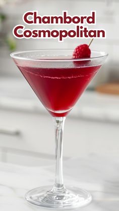 a close up of a drink in a glass with a cherry on the rim and text that reads, chambor cosmopolian