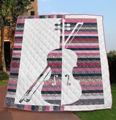 a quilted wall hanging with a violin on it