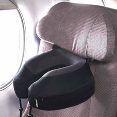 an airplane seat with two headrests on it's back facing the window