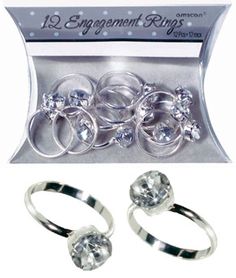 three engagement rings with clear crystal stones in the middle and two silver rings on each side