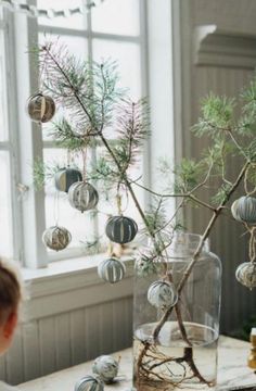 a young child looking at ornaments in a vase