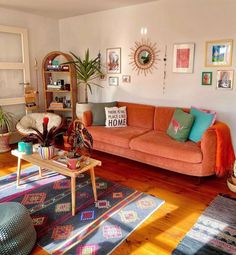 a living room filled with furniture and lots of pictures hanging on the wall above it