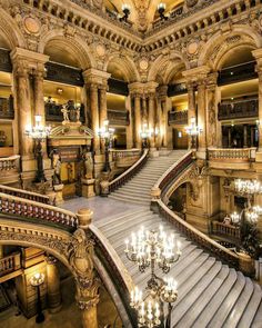 an ornate building with chandeliers and stairs