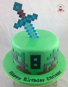 a green cake with a pixel design on top