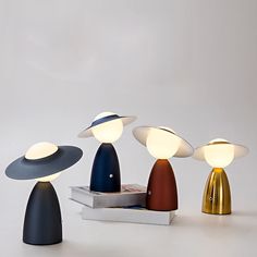 three different colored lamps sitting next to each other on top of a white countertop